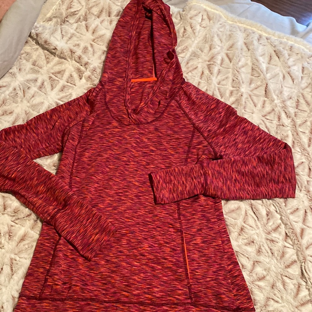 long sleeve with hood, thumb holes, front pocket, and back pocket with zipper.